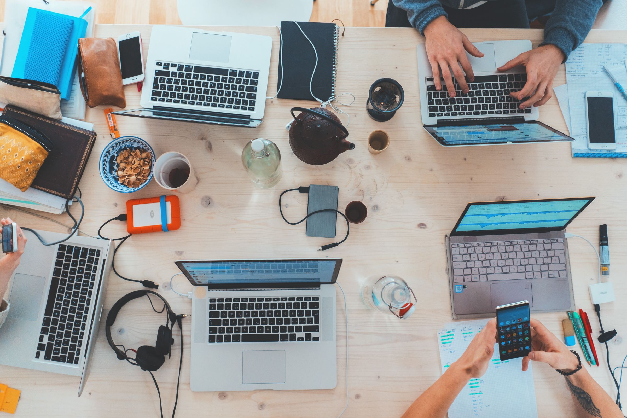 Arbeitstisch mit mehreren Laptops von oben